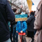 a young girl protesting against the war in ukraine